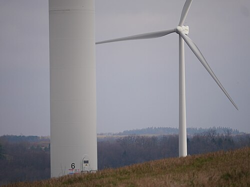 Two turbine of Patton Wind Farm, one of which is so close that only the lower tower is visible in the foreground