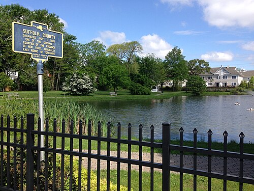 Sign referring to Suffolk County's 1683 founding located in Peterkin Park on Oak Street in Amityville.