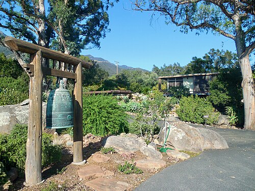 Temple bell (foreground) with the Gatehouse / Bookstore (background right)