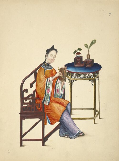 A woman dressed in an ao and a trousers, she is playing a small drum, from 1800.