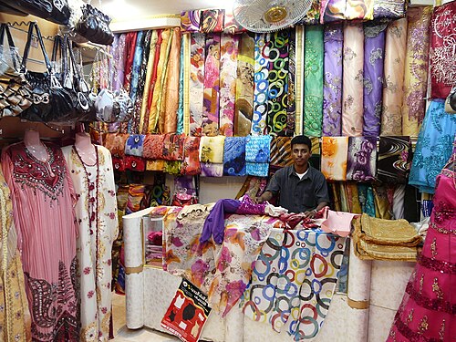 محل أقمشة في مدينة المكلا، اليمن، الواقعة على قناة مائية.