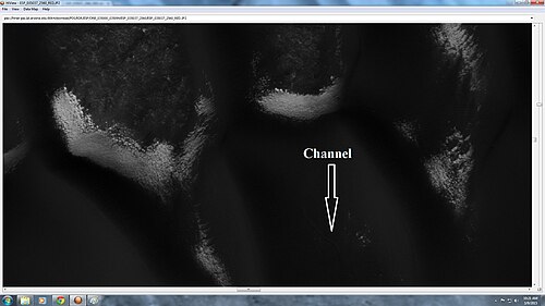 Close-up of defrosting dunes, as seen by HiRISE under HiWish program. Some ripples and a small channel are also visible.